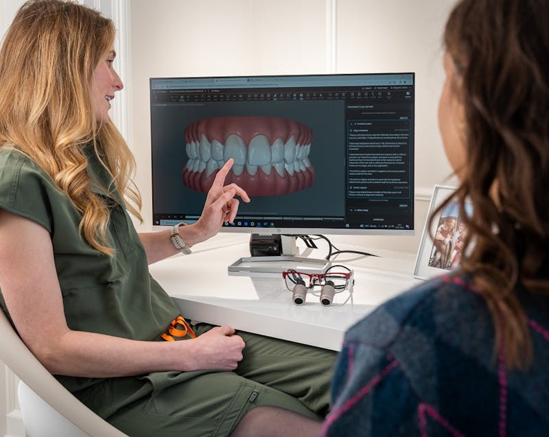 a dentist explaining something to her patient